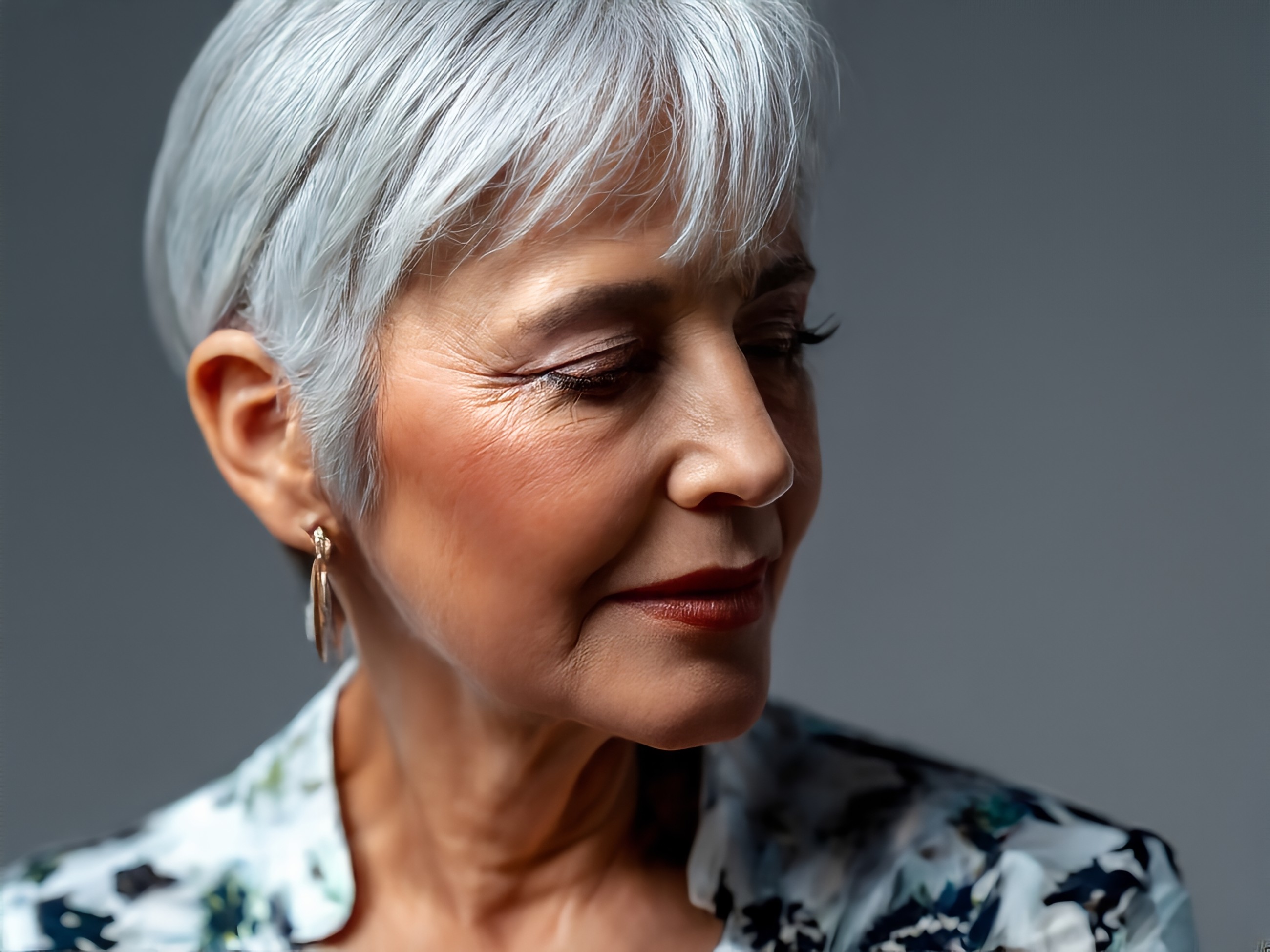 stunning portrait of a senior woman in a studio setting, natural lighting, silver hair, beautiful, looking to side, natural, authentic, real, pattern blouse, real skin wrinkles, natural beauty.jpg